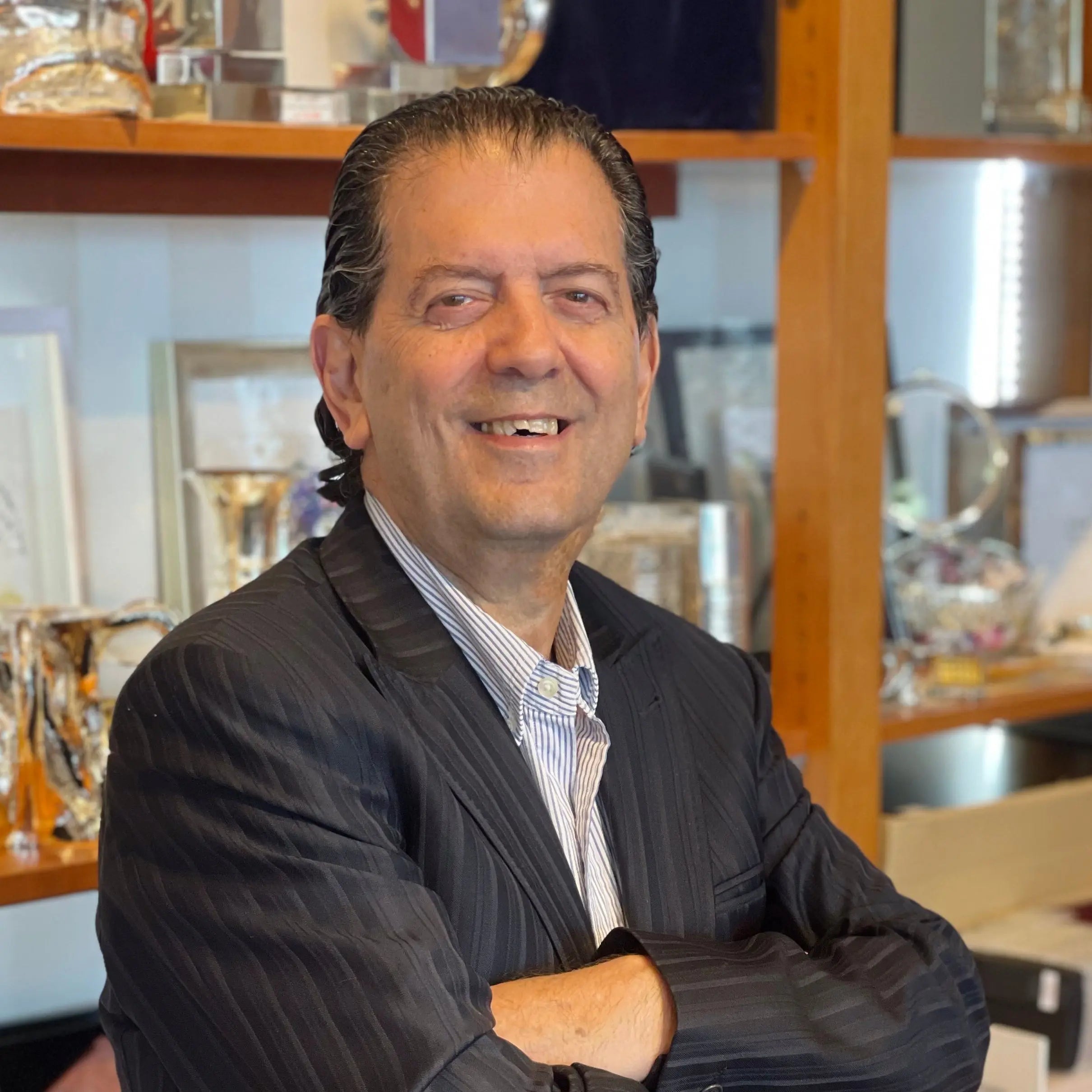 Zion Hadad examining silver Judaica at Piece gallery, Hilton Tel Aviv